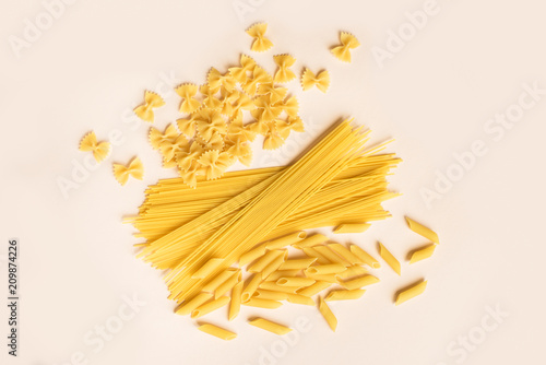 various pasta on pink background
