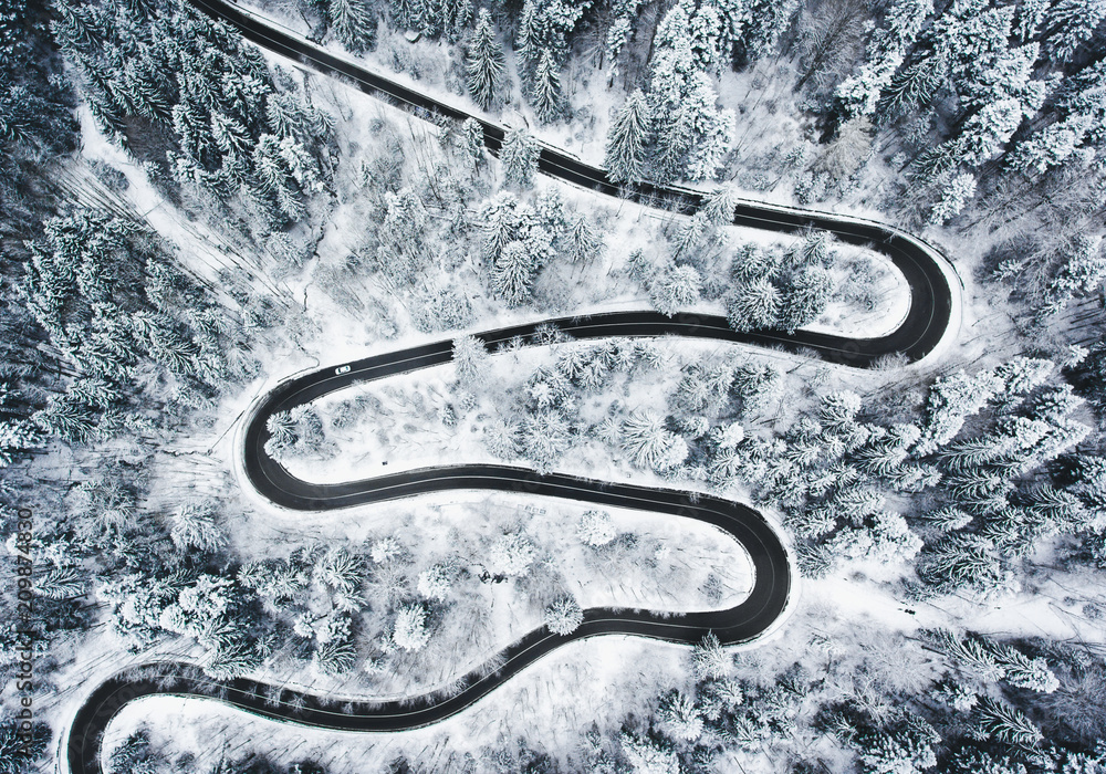 Winding winter road in and forest whit trees covered in snow