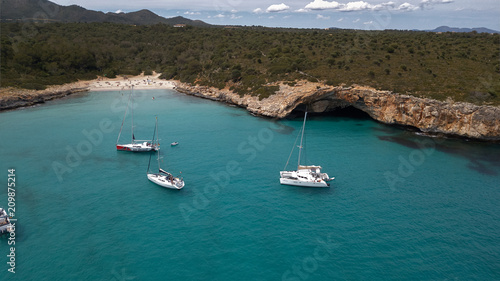 luxury yacht on the coast of Majorca, overlooking cliffs © jujopeto