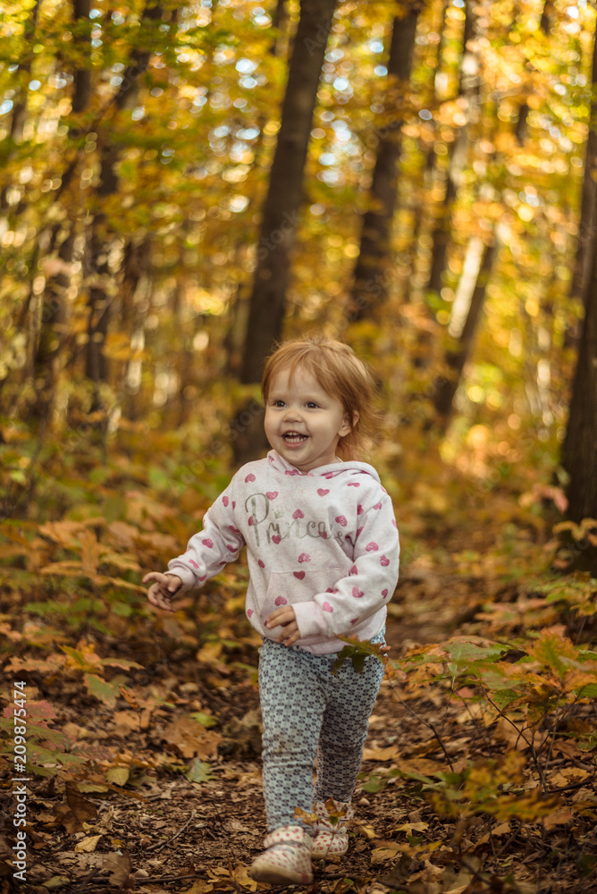 happy little child, baby girl laughing and playing in autumn park happy little child, baby girl laughing and playing in autumn park