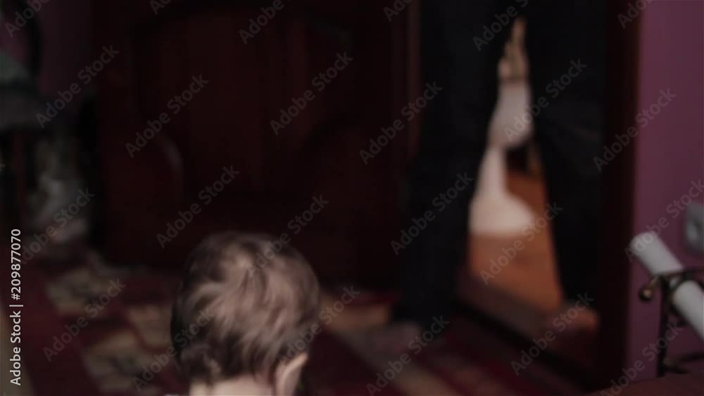 Cute Little Boy Drinking From Plastic Bottle And Dancing,In a dark room, a little boy danced with music Cute Little Boy Drinking From Plastic Bottle And Dancing,In a dark room, a little boy danced with music