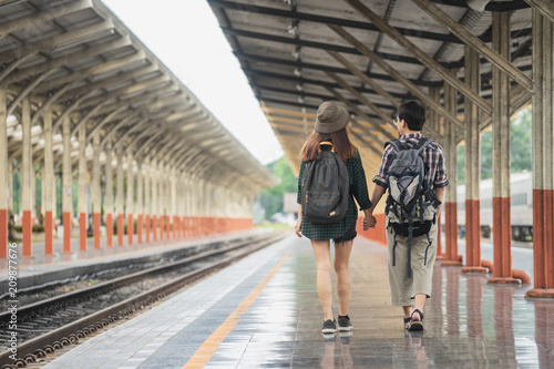 Happy young couple on railway station platform 