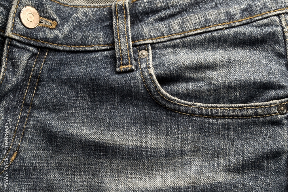 Close up on blue jeans front pocket Close up on blue jeans front pocket