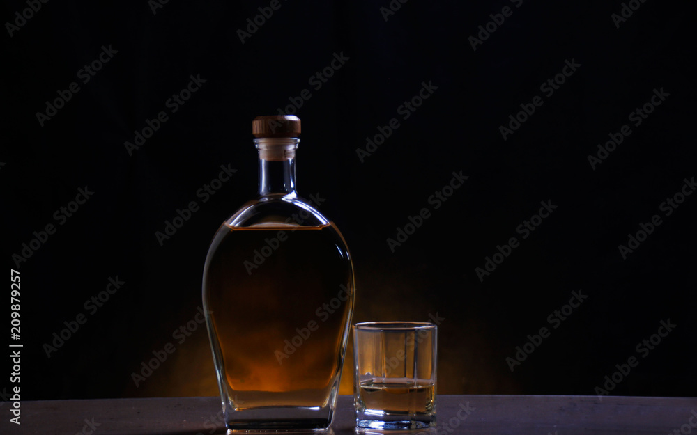 A bottle and a glass of alcoholic drinks A bottle and a glass of alcoholic drinks