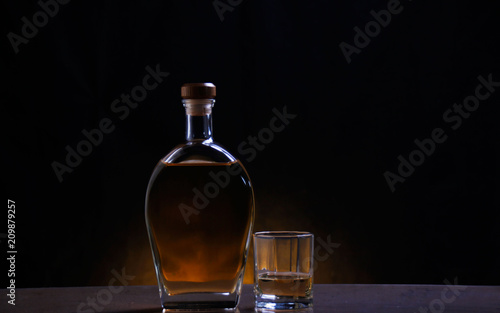 A bottle and a glass of alcoholic drinks