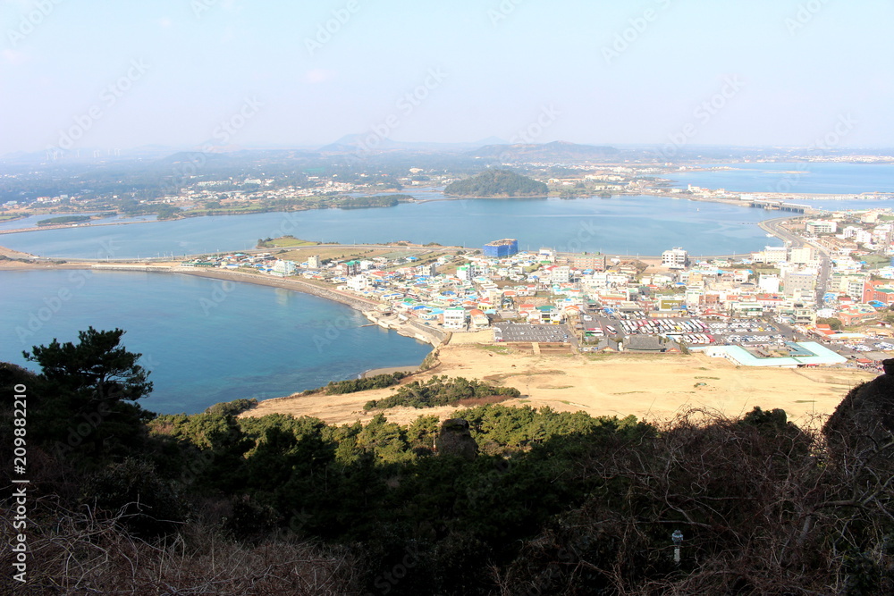 Cityscape and blue sea view from Seongsan Ilchulbong in Jeju island, South Korea