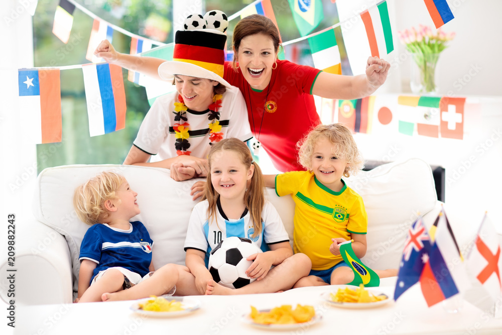 Fototapeta premium Fans watch football game. Family watching soccer.