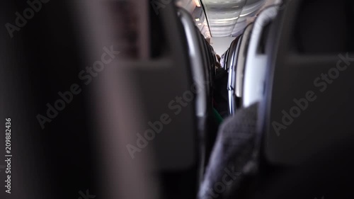 Interior of airplane with passengers on seats. shaking because of turbulence