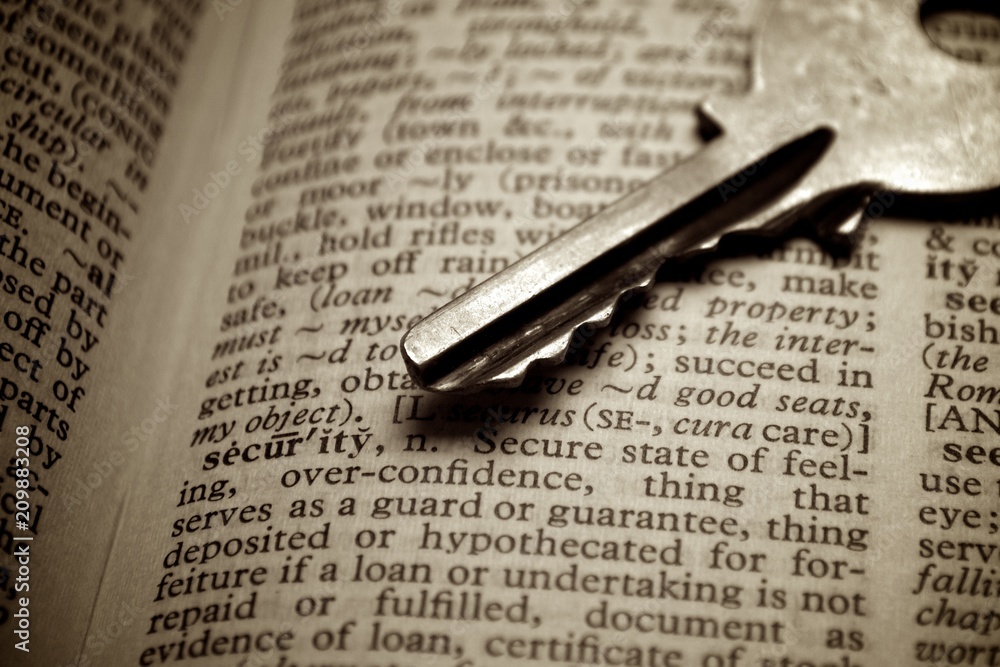 Fototapeta premium Old key point on security word on old dictionary