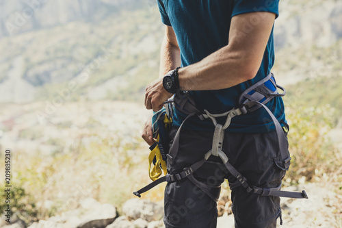 Male Climber Preparing for Climbing Outdoors