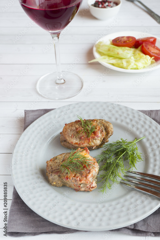 Delicious pieces of baked meat with fresh vegetables on the table Delicious pieces of baked meat with fresh vegetables on the table