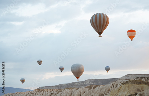 Hot air balloons flying over the rocks of Cappadocia