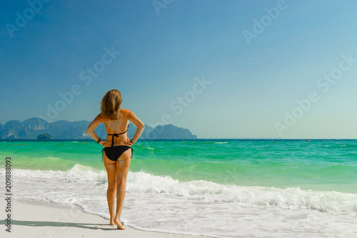 Cute woman relaxing on the summer beach.