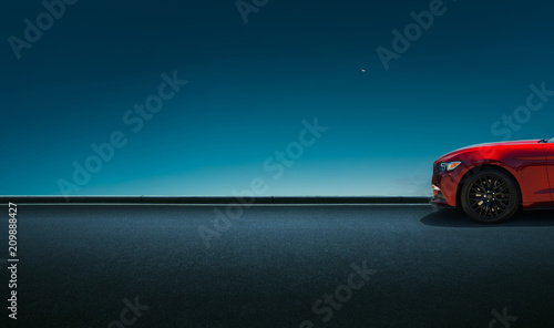 Sport car parked on road side with night sky background .