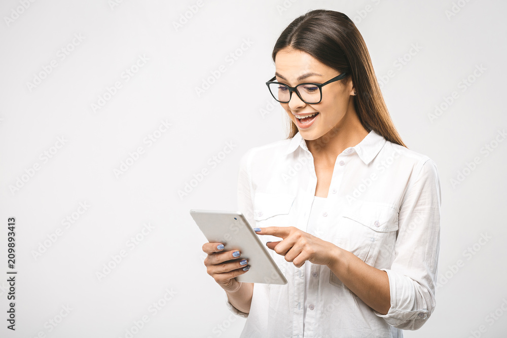 Portrait with copy space empty place of pretty charming confident trendy woman in classic shirt having tablet in hands isolated on white background