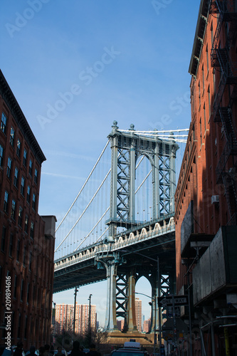A view of Manhattan Bridge from between two buildings in Brooklyn