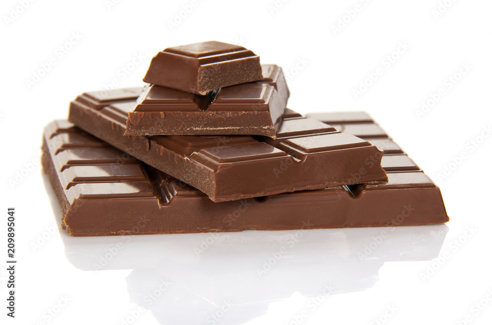 The whole tile of milk chocolate and slices isolated on white The whole tile of milk chocolate and slices isolated on white