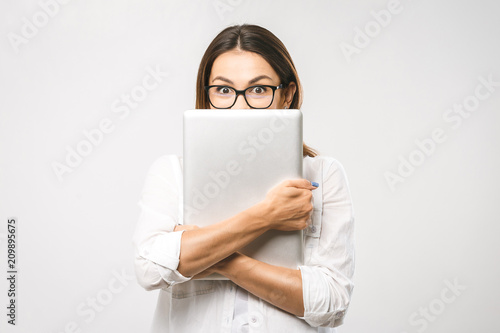 Wow! It's amazing. Portrait with copy space empty place of pretty charming confident trendy woman in classic shirt having tablet in hands looking at camera isolated on white background. © denis_vermenko