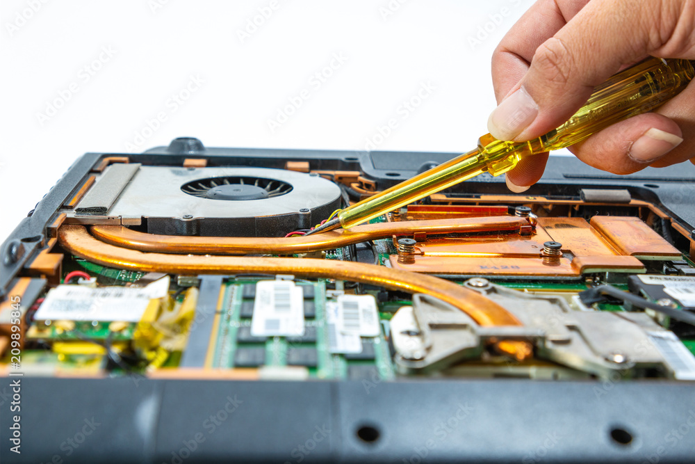 Naklejka premium Computer repair technician is repairing the notebook or repair laptop.
