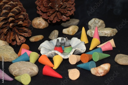 Foto Colorful incense cone on black background