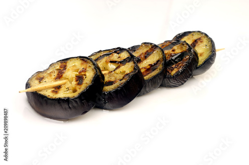 grilled aubergines on a spit