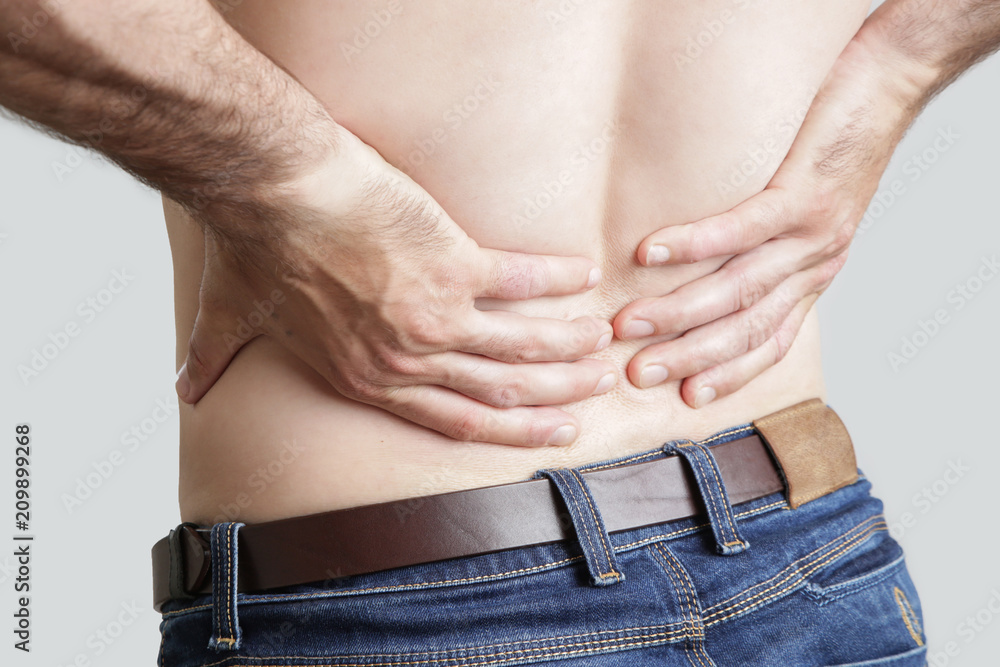 Fototapeta premium Studio shot of young man with pain in back