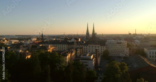 Helsinki cityscape, C4K aerial rising view of punavuori and saint johns church, in the city of Helsinki, on a sunny summer evening dusk, in Helsingfors, Uusimaa, Finland photo