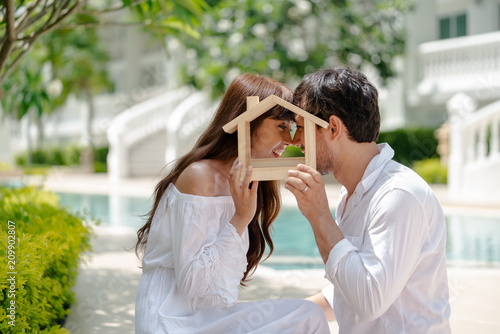 couple with small wooden house