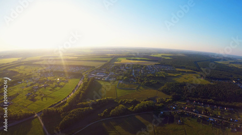 Panoramic aerial view of green fields and meadows in countryside, nature landscape