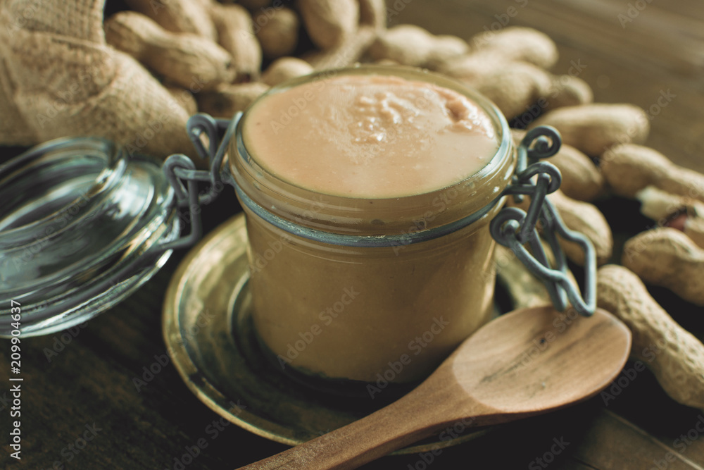 Homemade Peanut Butter in Glass Jar as Healthy Breakfast Vegetarian Food Concept Homemade Peanut Butter in Glass Jar as Healthy Breakfast Vegetarian Food Concept