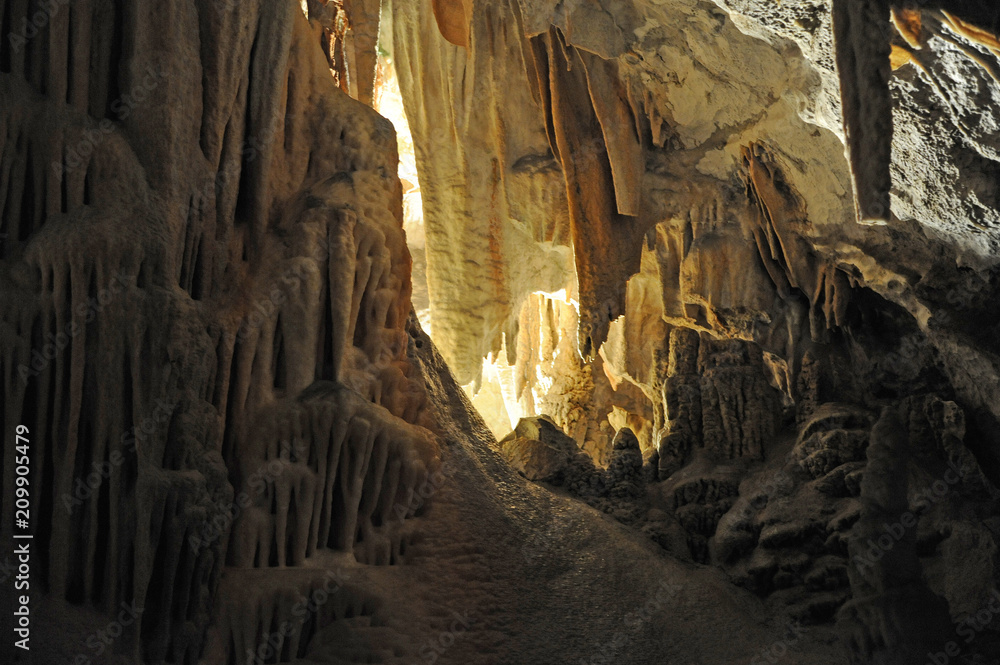 underground view of stalactites and stalagmites in natural halls in Postojna cave, Slovenia, Europe