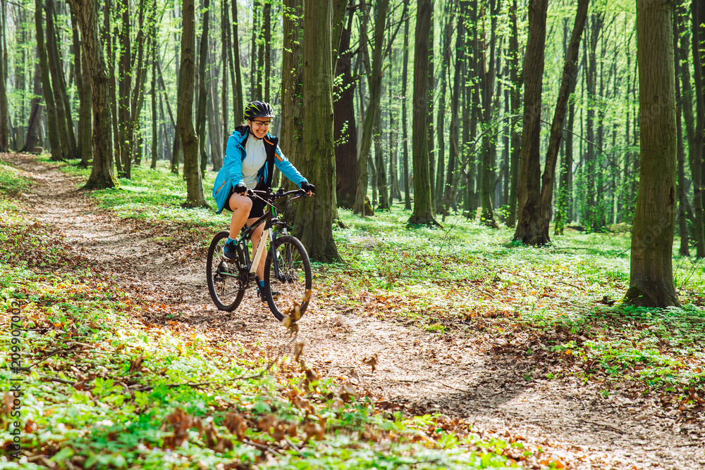 couple riding bicycle in forest in warm day couple riding bicycle in forest in warm day