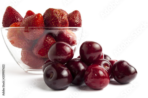 Strawberries with cherries on a white background