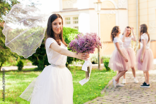 Wedding veil of Bride-to-be ifluttering in the wind photo