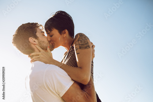 Beautiful couple kissing outdoors photo