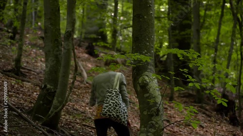 Young Woman is walking in Forest Background photo