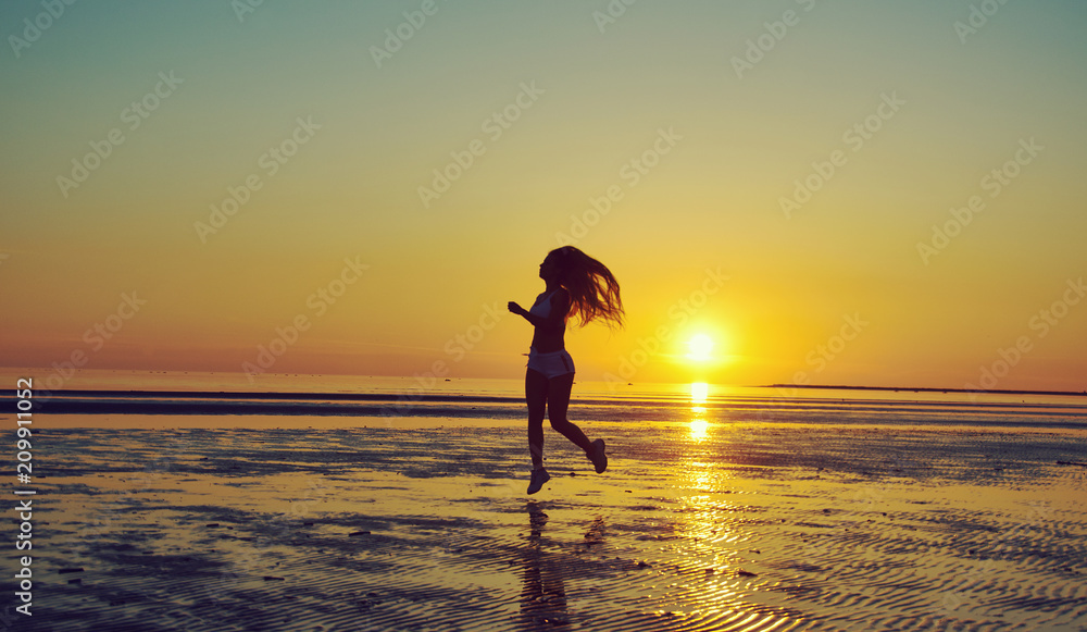  girl running by the sea on the beach