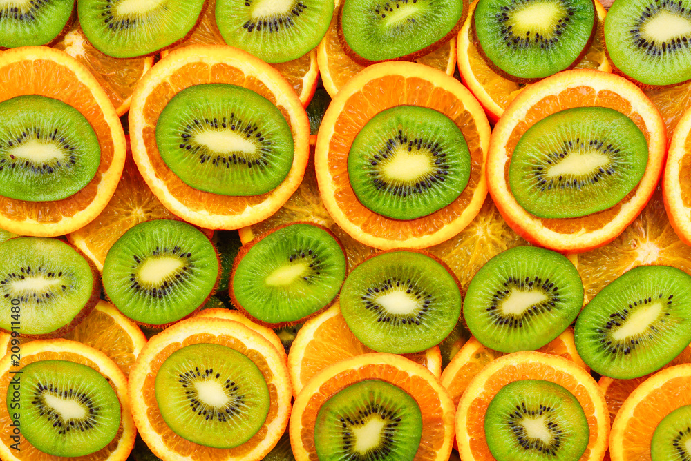 Fruity background set of slices of orange fruit and kiwi. Many slices of kiwi fruit and orange fruit, Fresh kiwis and orange fruit, interesting composition Fruity background set of slices of orange fruit and kiwi. Many slices of kiwi fruit and orange fruit, Fresh kiwis and orange fruit, interesting composition