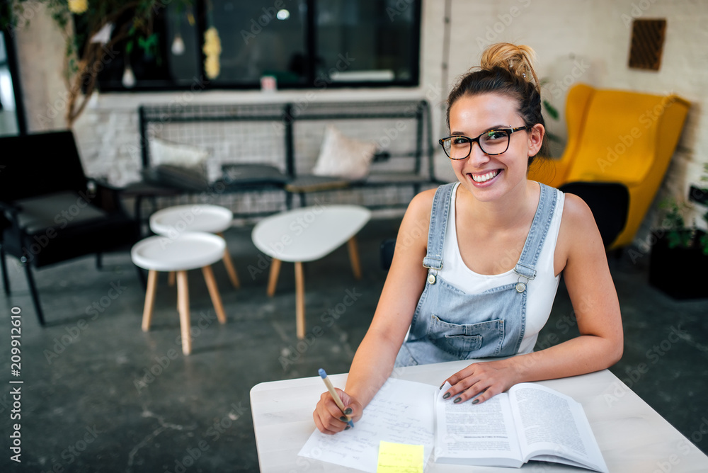 Portrait of a girl in eyeglasses studying. Looking at camera. Portrait of a girl in eyeglasses studying. Looking at camera.