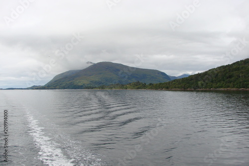 Panorama of the Gulf of Scottish Fjords from the boat deck against the background of the cloudy northern sky.