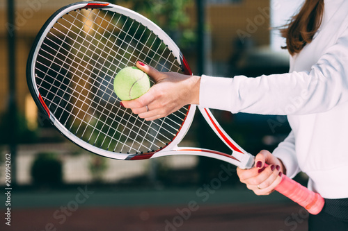 female holding tennis ball and tennis racket, prepare to serve. tennis player starting set © Peakstock