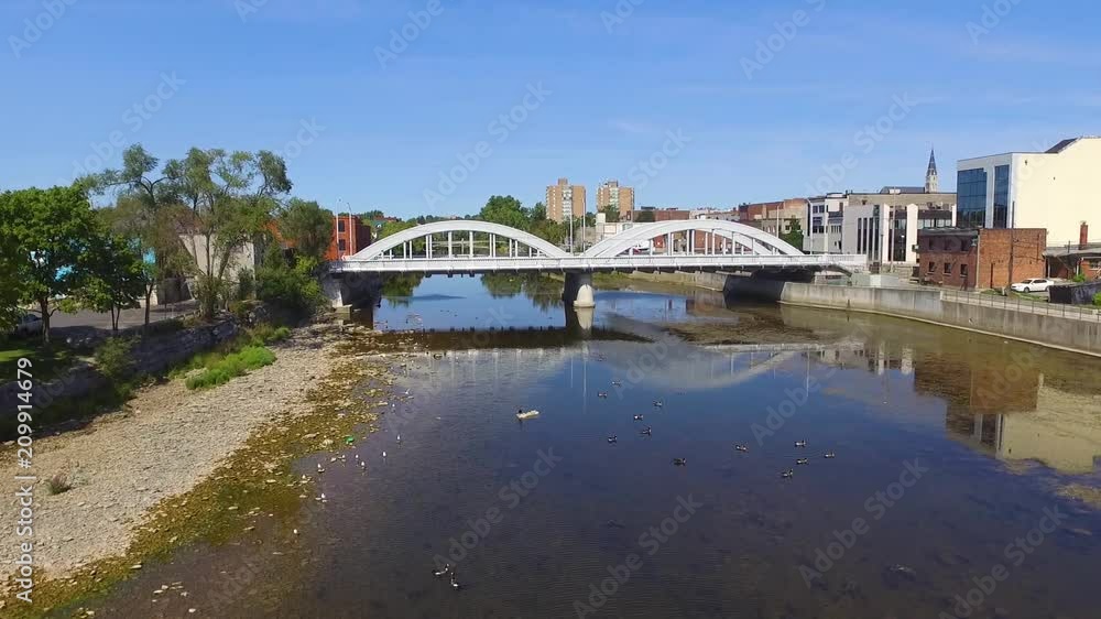aerial shot of a river under old style bridge aerial shot of a river under old style bridge