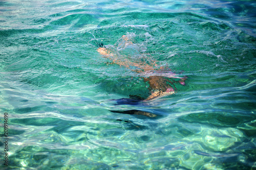 Little girl enjoying snorkeling in beautiful Croatian sea