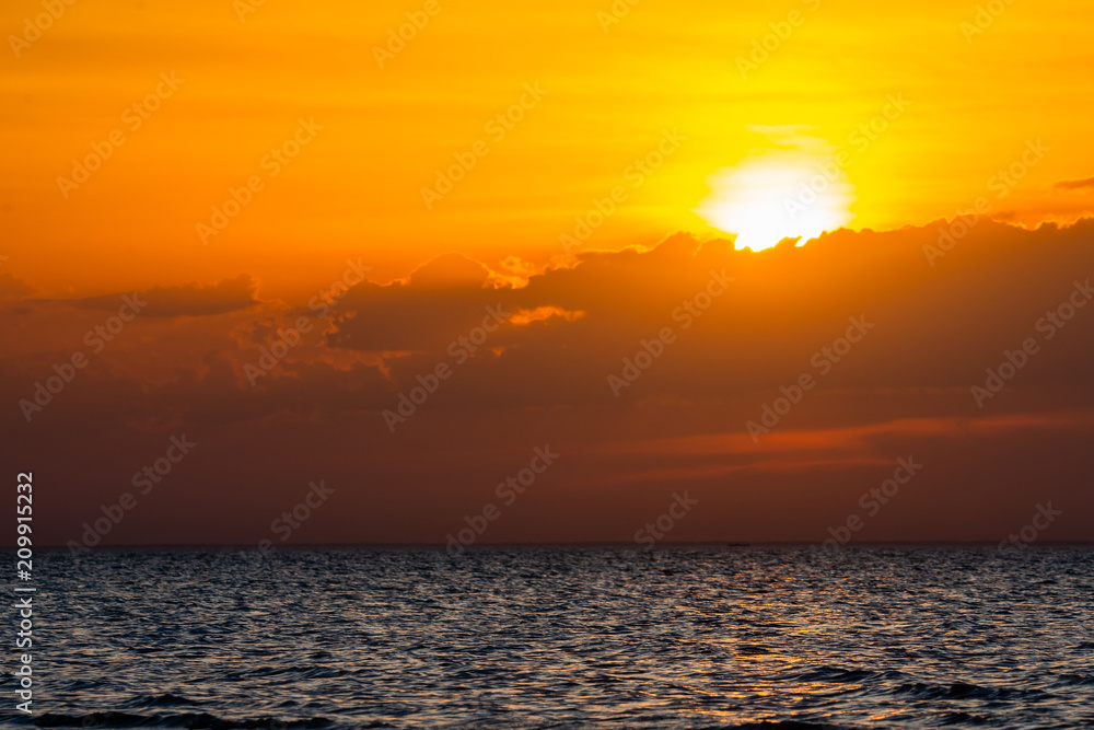 Beautiful cloudscape over the sea, scenic dramatic golden sunset