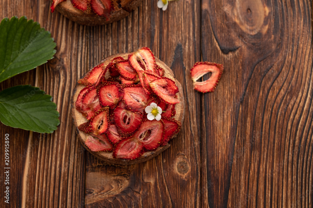 Dried strawberry on a wooden background. Summer concept.Top view. Dried strawberry on a wooden background. Summer concept.Top view.