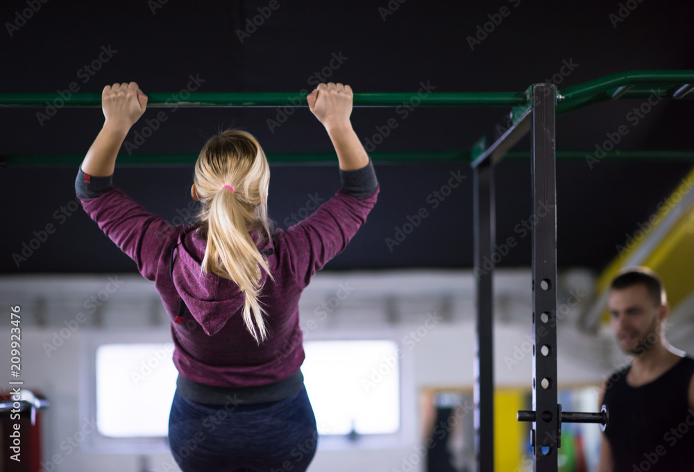 woman doing pull ups on the horizontal bar woman doing pull ups on the horizontal bar