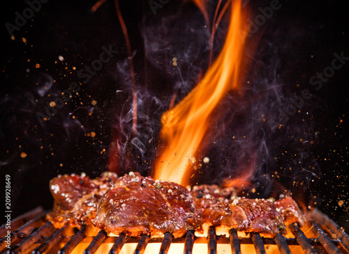 Beef steak on the grill with flames