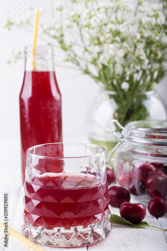 glass with cherry compote.Cherry drink. Fresh cherry cocktail. Fresh summer cocktail with cherry