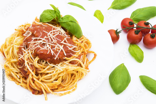 spaguetis a la bolognese dish with cheese and basil leaf photo