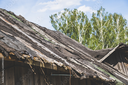 Fototapeta A dilapidated, collapsing village roof.